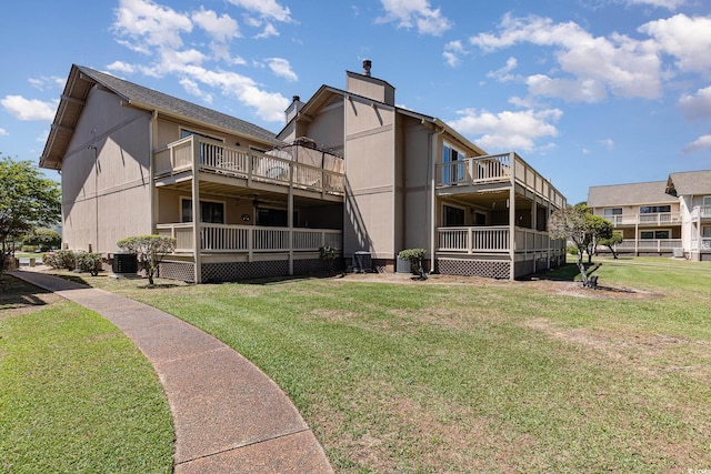 3015 Old Bryan Dr Unit 10-7, Myrtle Beach, SC 29577 - rear view of property with a yard, central air condition unit, and a chimney