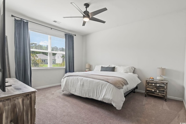 carpeted bedroom with baseboards and a ceiling fan