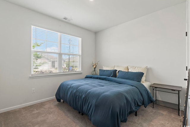 carpeted bedroom with baseboards