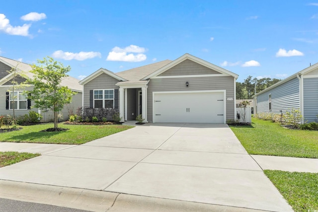 ranch-style home featuring an attached garage, a front lawn, and concrete driveway
