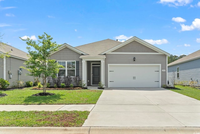 craftsman house with a garage, a front yard, and driveway