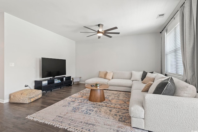 living room featuring ceiling fan, wood finished floors, and baseboards