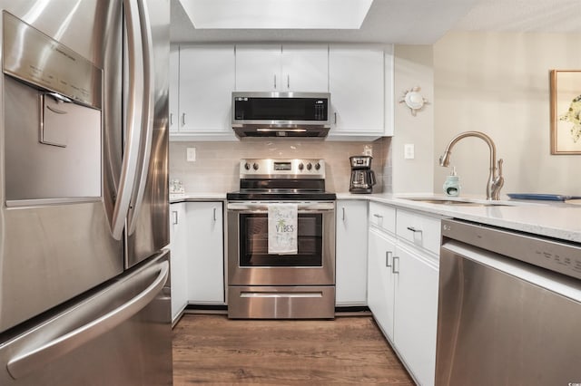 223 Maison Dr Unit F-4, Myrtle Beach, SC 29572 - kitchen with dark wood-style floors, light countertops, white cabinetry, stainless steel appliances, and a sink