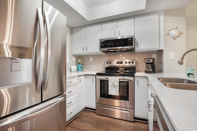 223 Maison Dr Unit F-4, Myrtle Beach, SC 29572 - kitchen featuring tasteful backsplash, white cabinetry, dark wood-type flooring, stainless steel appliances, and a sink