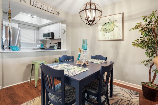 223 Maison Dr Unit F-4, Myrtle Beach, SC 29572 - dining space featuring a chandelier, a tray ceiling, baseboards, and wood finished floors