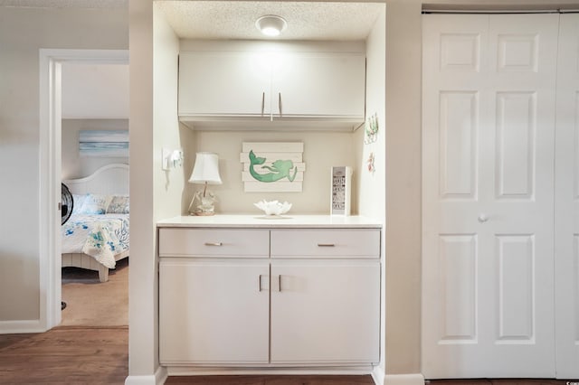 223 Maison Dr Unit F-4, Myrtle Beach, SC 29572 - bar with a textured ceiling, wood finished floors, and baseboards