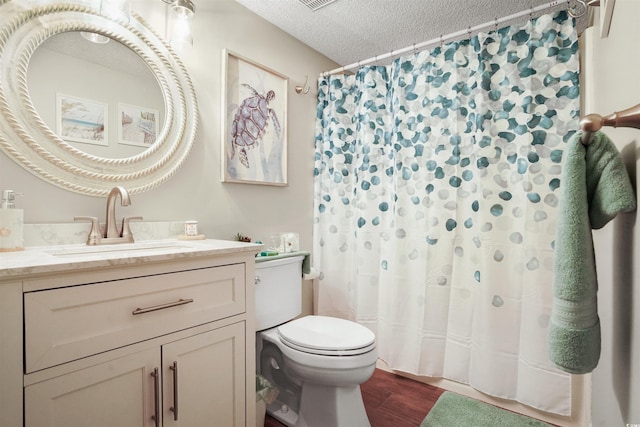 223 Maison Dr Unit F-4, Myrtle Beach, SC 29572 - bathroom with vanity, a textured ceiling, a shower with curtain, toilet, and wood finished floors