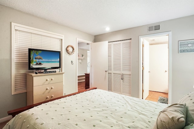 223 Maison Dr Unit F-4, Myrtle Beach, SC 29572 - bedroom featuring visible vents, a closet, a textured ceiling, and wood finished floors
