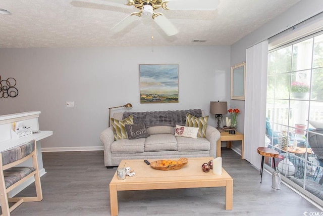 646 Tupelo Ln Unit 4E, Longs, SC 29568 - living room with wood finished floors, a textured ceiling, and a ceiling fan
