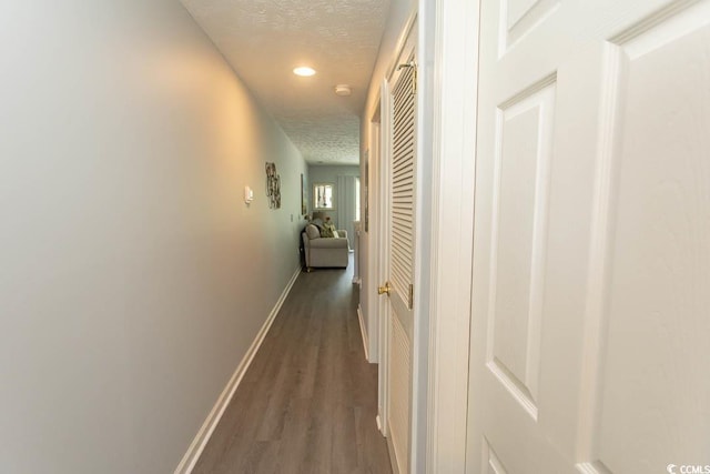 646 Tupelo Ln Unit 4E, Longs, SC 29568 - hall featuring a textured ceiling, dark wood finished floors, and recessed lighting
