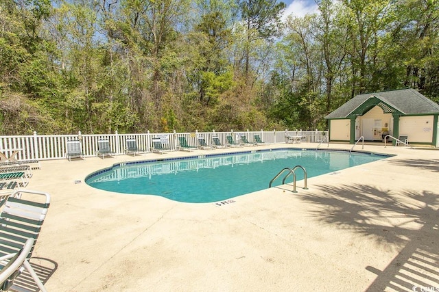 646 Tupelo Ln Unit 4E, Longs, SC 29568 - community pool with a patio area and view of scattered trees