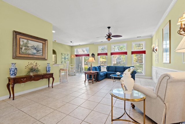 living area with baseboards, a ceiling fan, light tile patterned floors, and a wealth of natural light