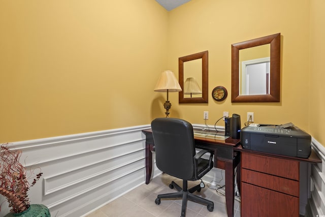 office space featuring light tile patterned floors and a wainscoted wall