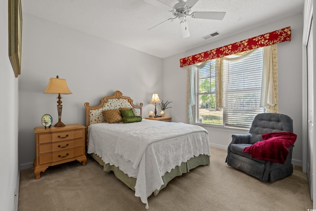 bedroom with visible vents, carpet, baseboards, and multiple windows