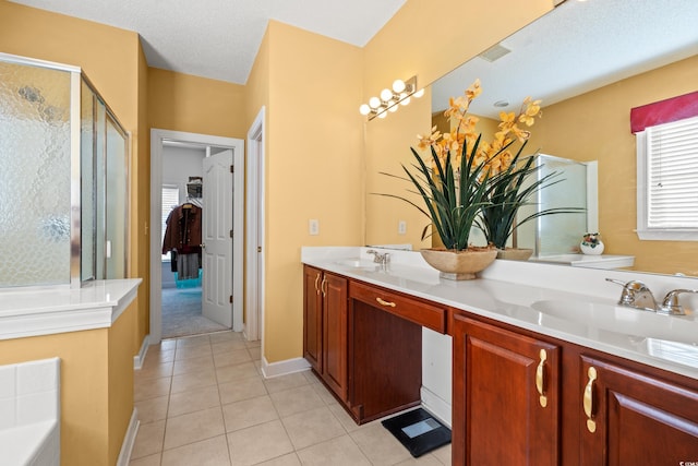 full bath featuring double vanity, a bath, tile patterned floors, a sink, and a stall shower