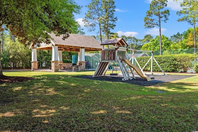 community playground with a yard, a gazebo, and fence