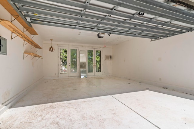 405 Emerson Dr, Myrtle Beach, SC 29579 - garage with a garage door opener, french doors, a wall unit AC, and baseboards