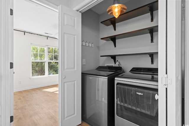 405 Emerson Dr, Myrtle Beach, SC 29579 - clothes washing area with washer and dryer, laundry area, light wood finished floors, and baseboards