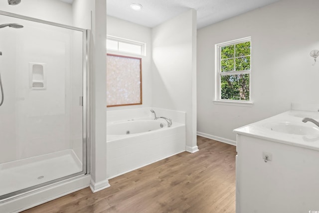 405 Emerson Dr, Myrtle Beach, SC 29579 - bathroom with a garden tub, a shower stall, wood finished floors, a sink, and baseboards