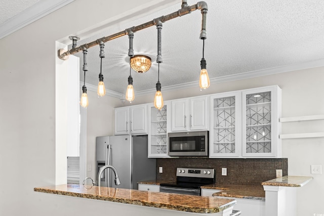 405 Emerson Dr, Myrtle Beach, SC 29579 - kitchen with glass insert cabinets, white cabinets, appliances with stainless steel finishes, a textured ceiling, and backsplash