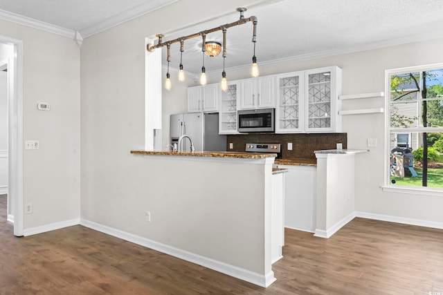 405 Emerson Dr, Myrtle Beach, SC 29579 - kitchen with crown molding, open shelves, white cabinets, appliances with stainless steel finishes, and dark wood-style flooring