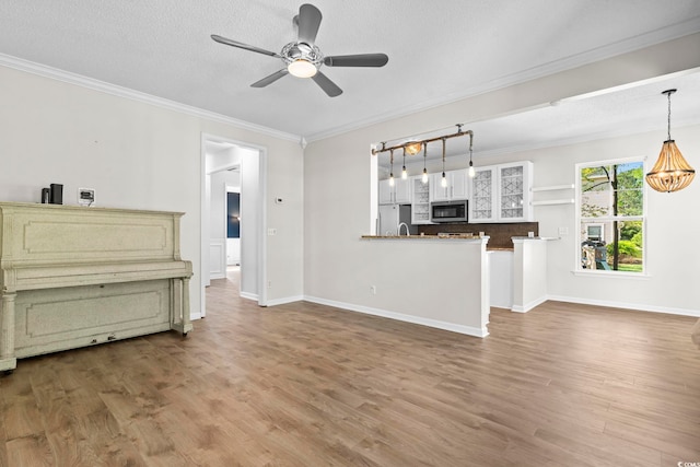 405 Emerson Dr, Myrtle Beach, SC 29579 - unfurnished living room featuring crown molding, baseboards, a ceiling fan, and wood finished floors