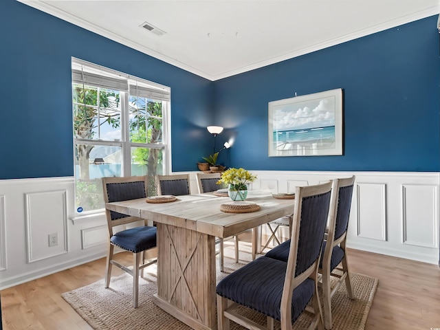 405 Emerson Dr, Myrtle Beach, SC 29579 - dining room featuring a decorative wall, visible vents, light wood-type flooring, and wainscoting