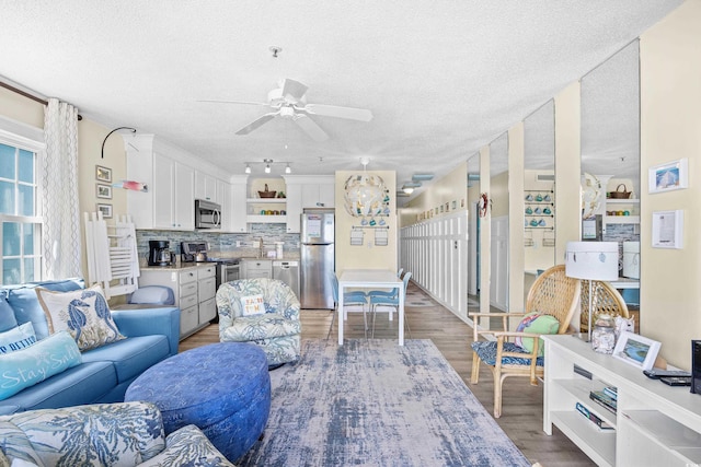 410 N Waccamaw Dr Unit 306, Murrells Inlet, SC 29576 - kitchen featuring appliances with stainless steel finishes, open shelves, light wood-style flooring, white cabinets, and a textured ceiling