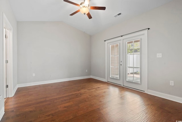 unfurnished room with ceiling fan, french doors, hardwood / wood-style floors, vaulted ceiling, and baseboards