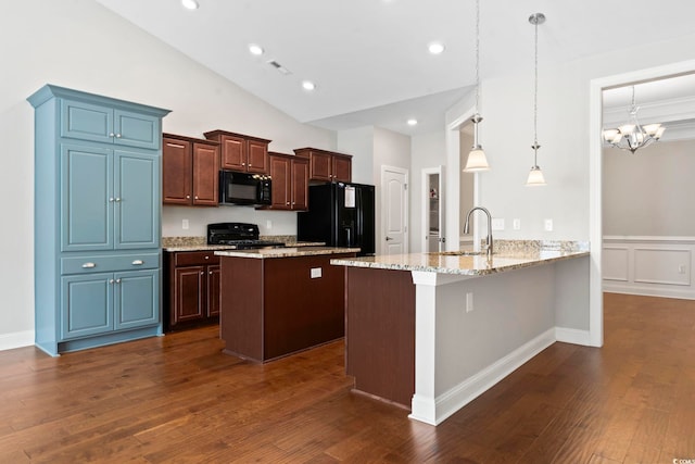 kitchen featuring black appliances, a sink, a peninsula, dark wood-style flooring, and a kitchen island