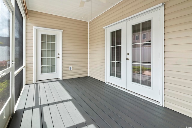 wooden terrace featuring french doors and ceiling fan