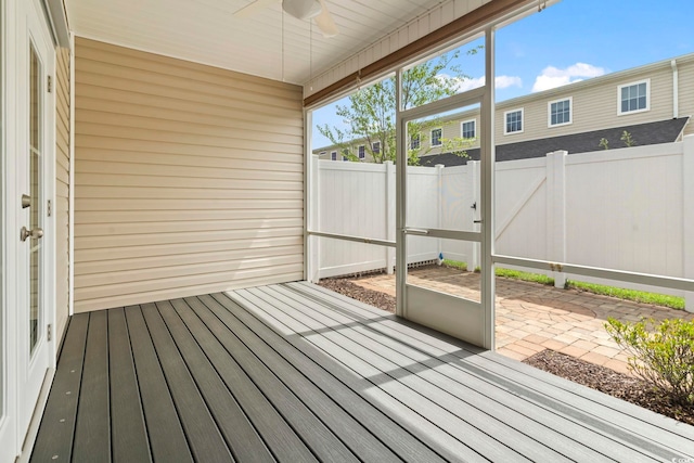 unfurnished sunroom with a ceiling fan