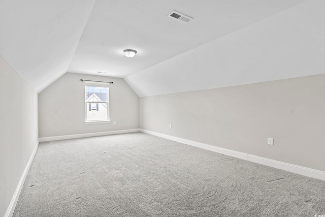 bonus room with vaulted ceiling, carpet floors, and baseboards
