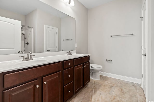 full bathroom featuring baseboards, double vanity, toilet, and a shower