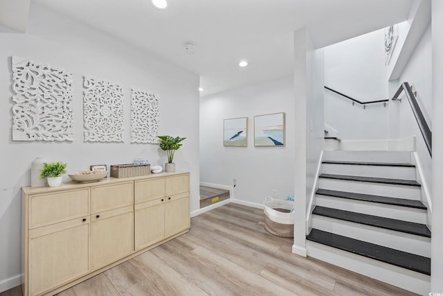 interior space featuring recessed lighting, baseboards, and wood finished floors