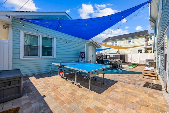 view of patio / terrace with a fenced backyard, central air condition unit, and outdoor dining space
