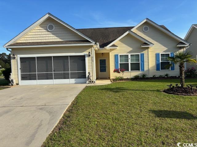ranch-style home with a front yard, driveway, a garage, and a shingled roof