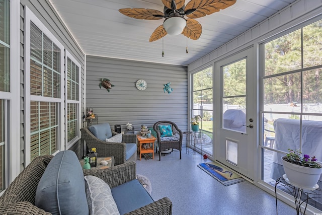 sunroom / solarium with a ceiling fan and an outdoor hangout area