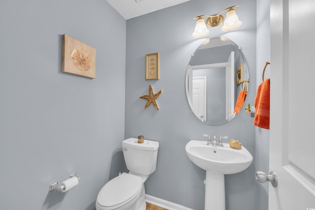 bathroom featuring toilet and a sink