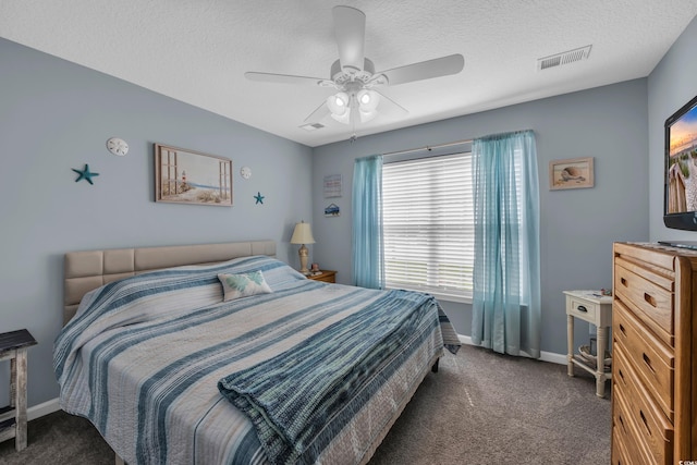 bedroom with carpet, baseboards, a textured ceiling, and ceiling fan