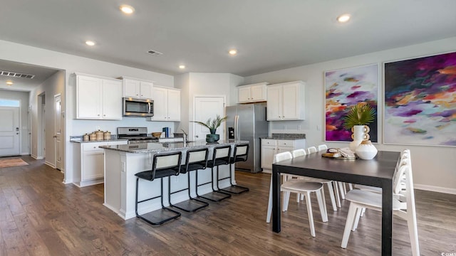 1446 Nokota Dr, Conway, SC 29526 - kitchen featuring appliances with stainless steel finishes, dark wood-type flooring, an island with sink, white cabinetry, and recessed lighting