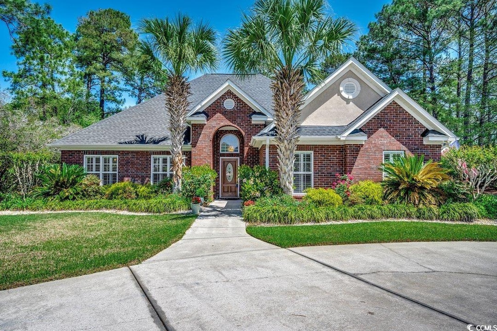 8261 Timber Ridge Rd, Conway, SC 29526 - view of front of property featuring brick siding, a front lawn, and a shingled roof