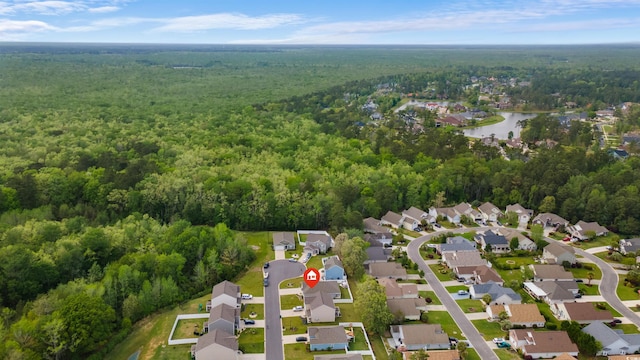 birds eye view of property with a water view, a residential view, and a wooded view