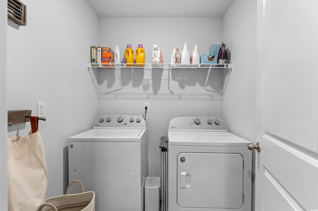 laundry area with laundry area and washer and clothes dryer