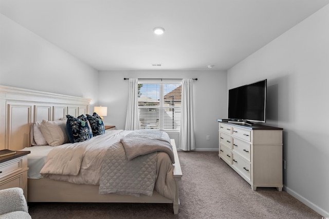 bedroom with baseboards, light carpet, and visible vents
