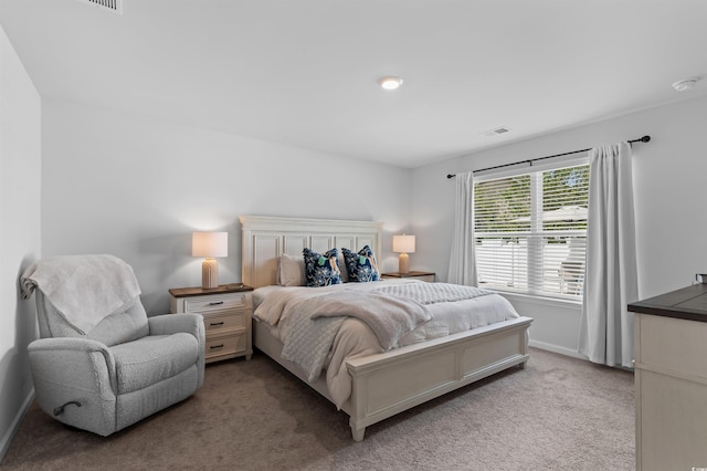 carpeted bedroom with baseboards and visible vents