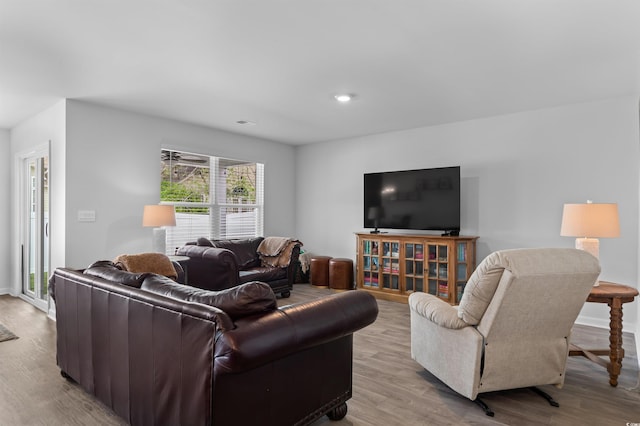 living area featuring baseboards and wood finished floors