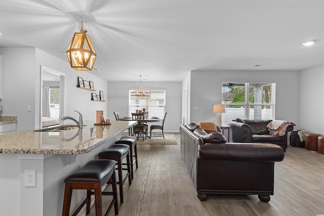 living area featuring recessed lighting, wood finished floors, and a chandelier