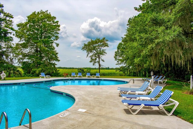 35 Red Skiff Ln Unit 35, Pawleys Island, SC 29585 - community pool featuring a patio area and a yard