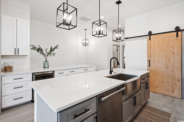 35 Red Skiff Ln Unit 35, Pawleys Island, SC 29585 - kitchen with stainless steel dishwasher, a chandelier, a sink, and light wood-style floors